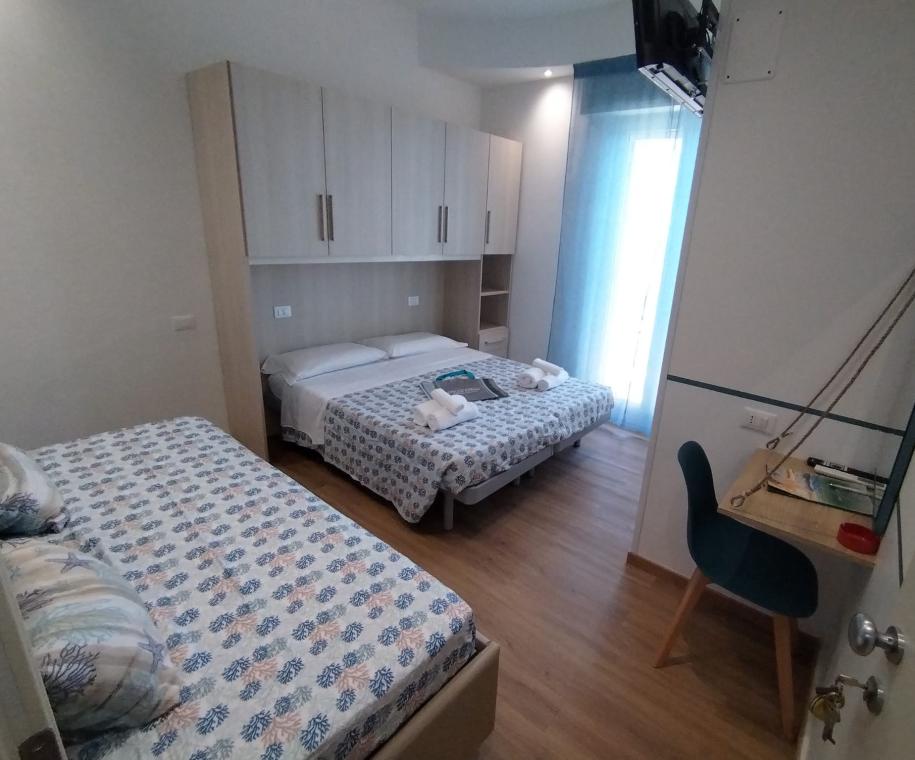 Camera con due letti e scrivania, decorazione marina.
