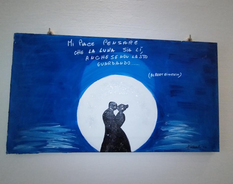 Dipinto con coppia sotto la luna e citazione di Einstein.